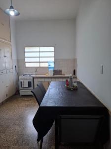 a kitchen with a table with two chairs in it at De Paso Pergamino in Pergamino