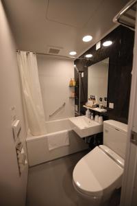 a bathroom with a toilet and a sink and a tub at HOTEL SUI KANDA by ABEST in Tokyo +35 photos