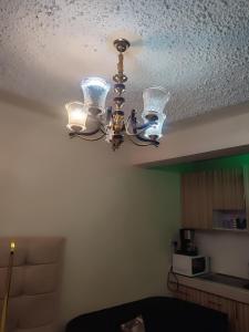a chandelier hanging from a ceiling in a room at Harmony Haven in Rungiri