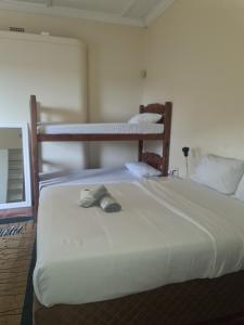a bed with a pair of shoes sitting on it at Lisokhanya GuestHouse in East London