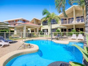 a swimming pool in front of a resort at Martys Little Beach No 1 Two Story Apartment in Nelson Bay