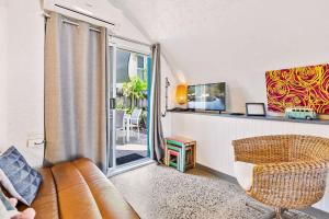 a living room with a couch and a window at Binishell Igloo 6 - Famous Beachfront Dome with Pool in Trinity Beach