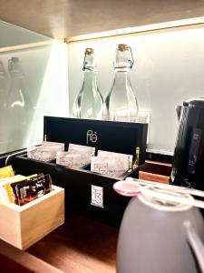 two glass bottles sitting on top of a table at Ra Premiere Simatupang in Jakarta