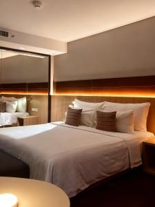 a large white bed in a hotel room at Ra Premiere Simatupang in Jakarta