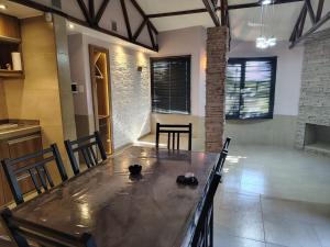 a dining room with a large table and chairs at Cabaña con parque en Tupungato in Tupungato +13 photos