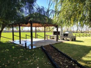 a picnic shelter with a grill in a park at Cabaña con parque en Tupungato in Tupungato