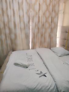 a bed with a comforter with a star on it at Harmony Haven in Rungiri
