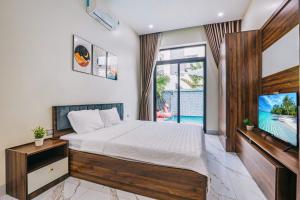a bedroom with a bed and a tv and a pool at LakeView Villa BT43-03 Sầm Sơn in Sầm Sơn +18 photos