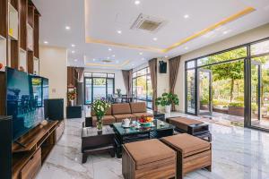 a living room with a couch and a table at LakeView Villa BT43-03 Sầm Sơn in Sầm Sơn