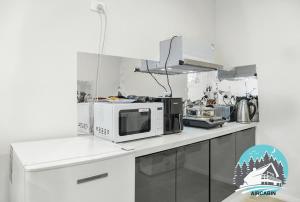a kitchen with a microwave on a counter at 1B house beachside comfy stay in Collaroy +5 photos