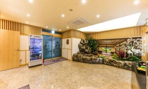 an empty lobby with a large room with a plant at Daeheung Manwol Hotel in Daejeon