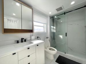 a bathroom with a toilet and a glass shower at ION House - Near Shopping Kennedy Station Easy Transit Downtown in Toronto
