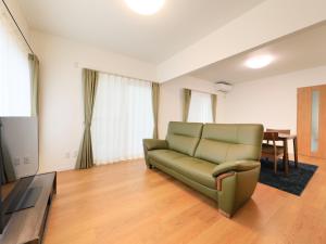a living room with a couch and a table at Knowledge House in Odawara
