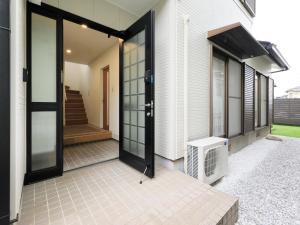 an open door of a house with a heater at Knowledge House in Odawara