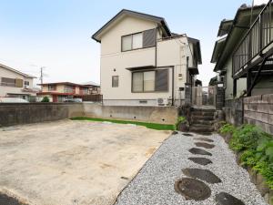 a house with a driveway in front of it at Knowledge House in Odawara