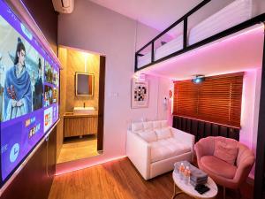 a living room with a couch and a tv at Bugis Social-Newly Renovated in Singapore