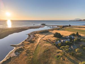 an aerial view of the shoreline of a house and the ocean at Shepherd's Cottage at Lisdillon Estate in Little Swanport