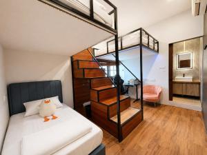 a bedroom with a bunk bed and a staircase at Bugis Social-Newly Renovated in Singapore