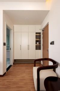 a living room with white cabinets and a wooden floor at Cyan Sầm Sơn Hotel in Sầm Sơn +31 photos