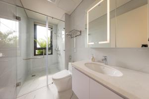 a white bathroom with a toilet and a sink at Cyan Sầm Sơn Hotel in Sầm Sơn