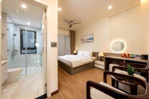 a hotel room with a bed and a bathroom at Cyan Sầm Sơn Hotel in Sầm Sơn