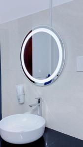 a bathroom with a white sink and a mirror at VICTORY - hotel 388 htp in Ho Chi Minh City