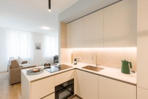 a kitchen with white cabinets and a sink at Alla Loggia in Udine