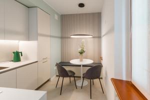 a small kitchen with a table and two chairs at Alla Loggia in Udine +14 photos