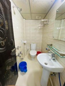 a bathroom with a toilet and a sink at Hotel Plaza Sylhet in Sylhet