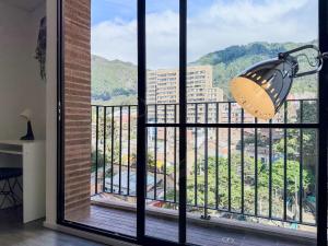 a large window with a butterfly light on a balcony at Loft Design Centro Internacional Bogotá in Bogotá