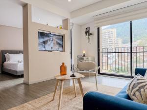 a living room with a couch and a table at Loft Design Centro Internacional Bogotá in Bogotá