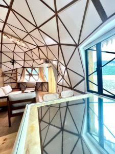 a room with a geometric ceiling and a window at Coconest THREE Langkawi in Tanjung Rhu