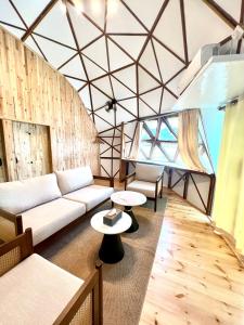 a living room with a couch and a table at Coconest THREE Langkawi in Tanjung Rhu
