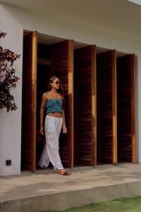 a woman standing in a doorway of a building at UNU Boutique Hotel -- Adults Only -- in Ahangama