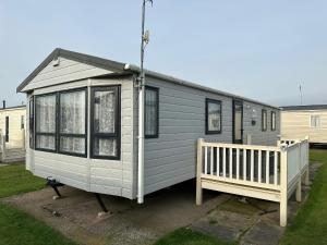 a gray tiny house with a porch and a bench at C43 The Hideout in Rowen