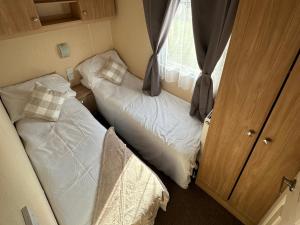 a small room with two beds and a window at C43 The Hideout in Rowen +15 photos