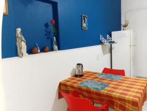 a dining room table with red chairs and a blue wall at PUNTO FIJO in Zárate