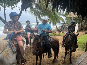 a group of people riding horses on the beach at Mar Villa Eco Lodge Surf & Kite Perla Marina by Encuentro Beach in Sosúa