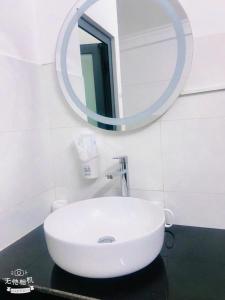 a white sink in a bathroom with a mirror at VICTORY - hotel 388 htp in Ho Chi Minh City +20 photos
