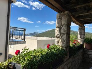 a view from the balcony of a house with flowers at Apartmani Sunset in Neum