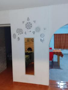 a room with a mirror with stickers on the wall at PUNTO FIJO in Zárate +4 photos