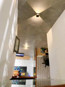 a living room with a ceiling with a tv on it at Hotel Tâm Đan in Ðông Tác (1) +23 photos