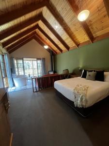 a bedroom with a large bed in a room at Lemonthyme Wilderness Retreat in Moina