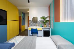 a bedroom with a bed and a desk with a chair at Parkland Hotel in Brinchang +28 photos