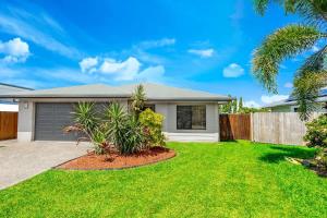 a house with a fence and a yard at Tropical Dreams - Spacious Retreat with Private Pool in Smithfield