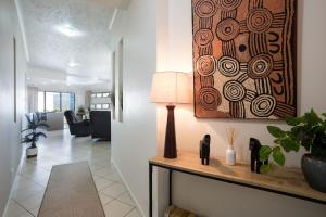a living room with a table with a lamp on it at Panorama Cairns - City & Coastal Views with Pool in Cairns