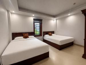 a bedroom with two beds and a window at Cong Hoa Homestay in Vũ Lâm +10 photos