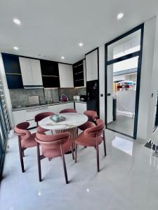 a kitchen with a table and chairs in a kitchen at SunQ Haven in Meyhomes in Phú Quốc