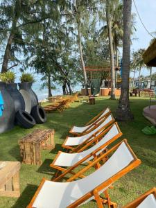 a group of chairs sitting on the grass in a park at SunQ Haven in Meyhomes in Phú Quốc