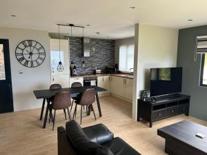a kitchen and living room with a table and chairs at Banana Tree Lodge in Jamestown